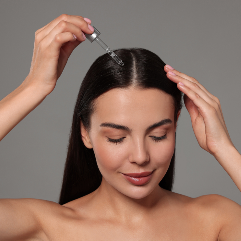 Applying hair serum to scalp